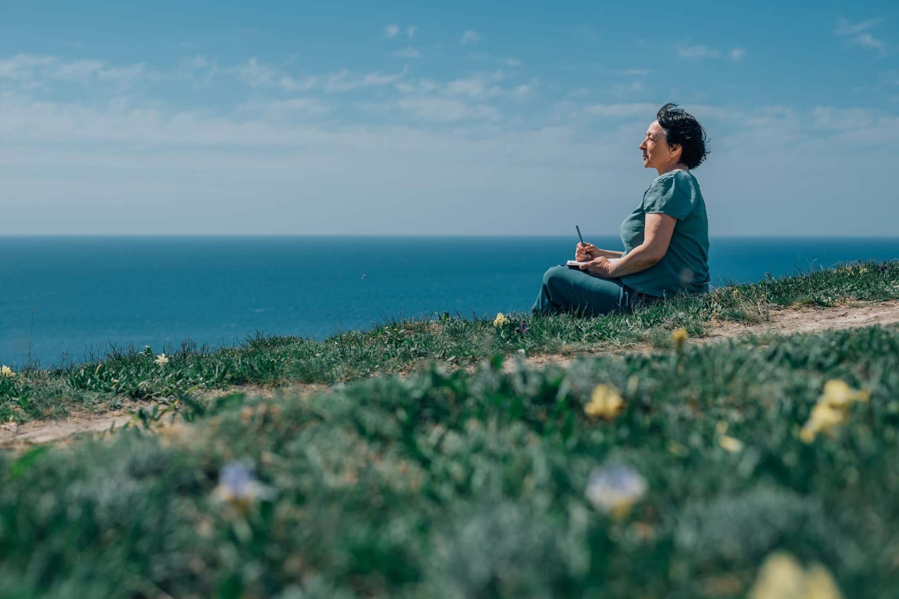 adult woman thoughtfully writing